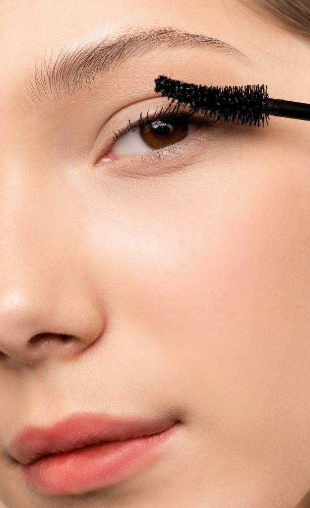 woman applying black mascara
