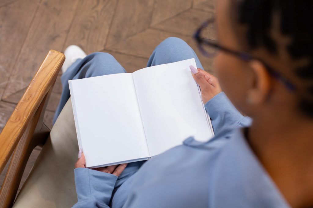 crop woman reading blank book