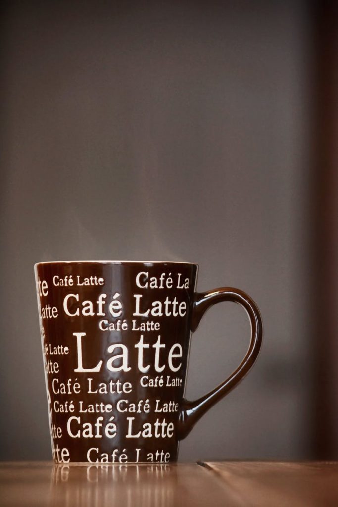 brown and white ceramic mug